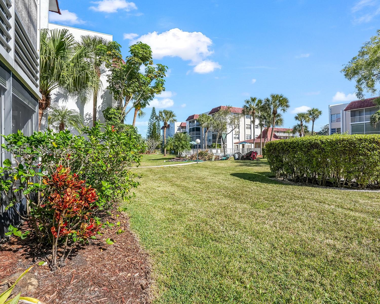 3531 Inverrary Drive, Unit 107 Lauderhill, FL 33319 - Photo 21 of 34 a view of a garden with a building in the background