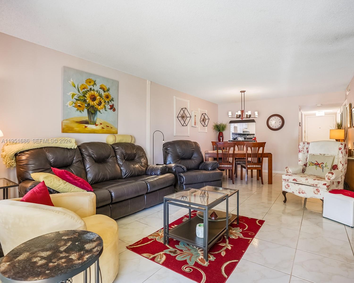 3531 Inverrary Drive, Unit 107 Lauderhill, FL 33319 - Photo 6 of 34 a living room with furniture and wooden floor