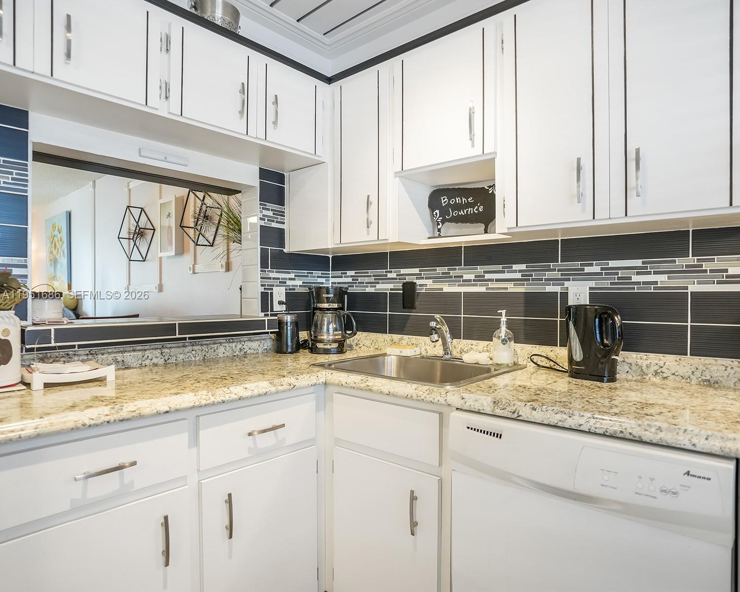 3531 Inverrary Drive, Unit 107 Lauderhill, FL 33319 - Photo 8 of 34 a kitchen with sink cabinets and stove