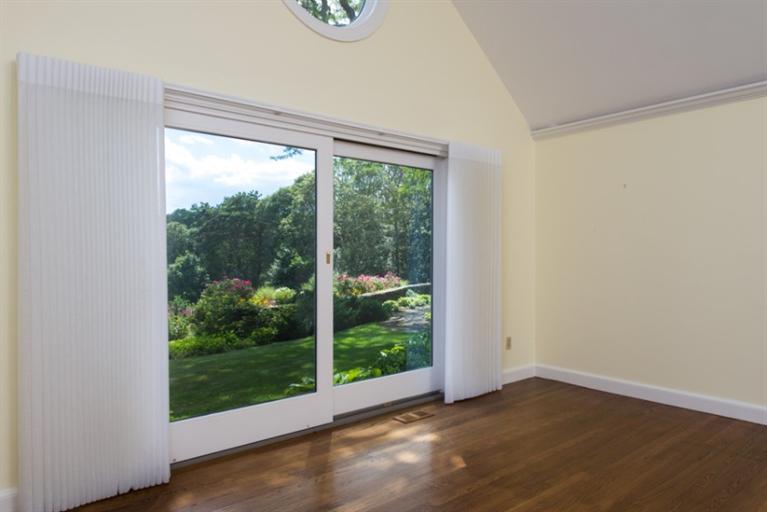 185 Ice Valley Road Osterville, MA 02655 - Photo 11 of 22 a view of an empty room with wooden floor and a window