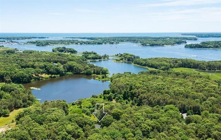 185 Ice Valley Road Osterville, MA 02655 - Photo 20 of 22 an aerial view of green landscape with trees houses and lake view