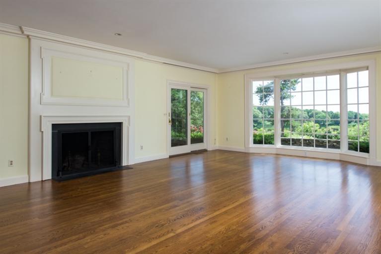 185 Ice Valley Road Osterville, MA 02655 - Photo 3 of 22 a view of empty room with wooden floor and fireplace