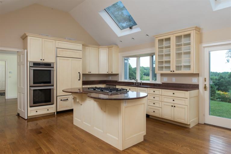 185 Ice Valley Road Osterville, MA 02655 - Photo 6 of 22 a kitchen with white cabinets and appliances
