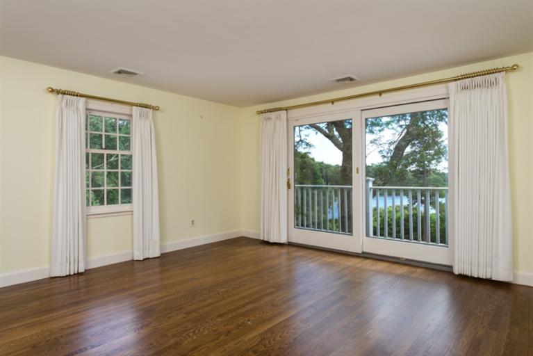 185 Ice Valley Road Osterville, MA 02655 - Photo 10 of 22 a view of an empty room with wooden floor and a window