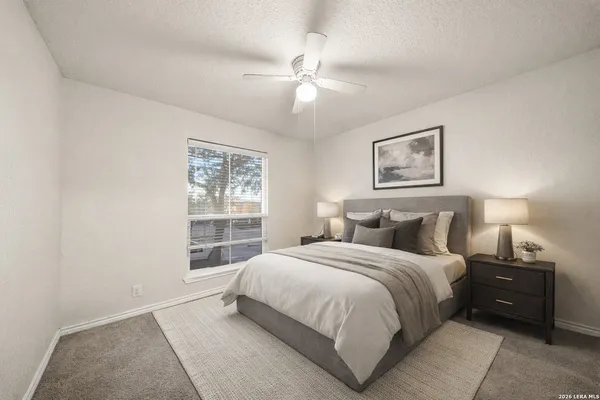 a bedroom with a bed and a window