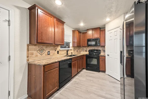 a kitchen with a sink stove and refrigerator