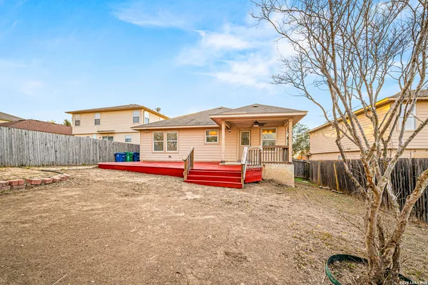 a view of a house with a yard and wooden fence