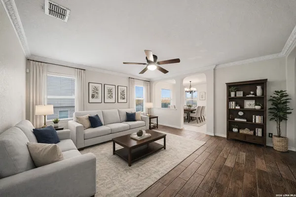 a living room with furniture and a wooden floor
