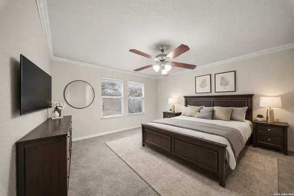 a spacious bedroom with a bed and a chandelier