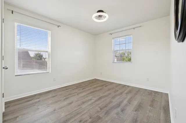 a view of a room with wooden floor and a window
