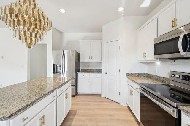 a view of livingroom with hardwood floor and a kitchen