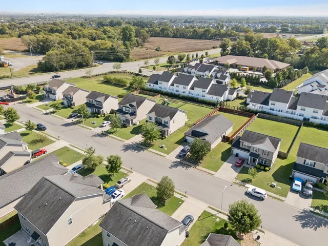 an aerial view of a building with garden space and ocean view