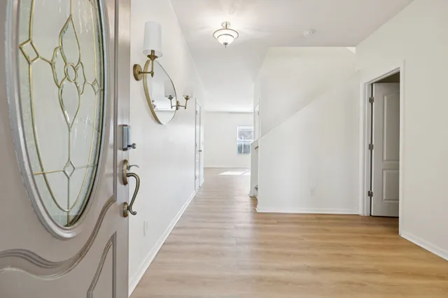 a view of a room with wooden floor and white walls