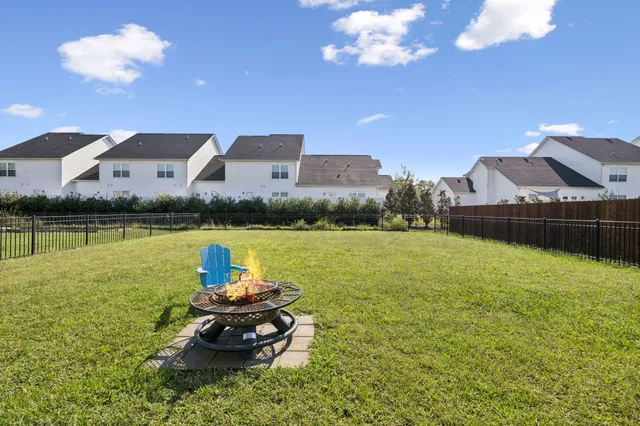 a view of a house with backyard and porch