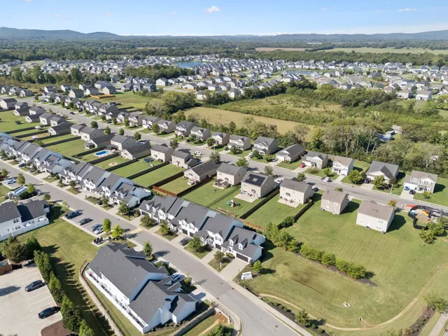 an aerial view of a house with a swimming pool