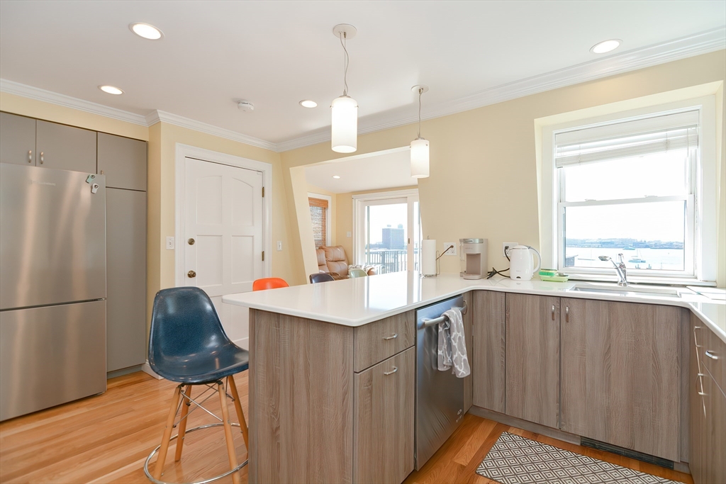 269 Webster Street, Unit 4 Boston, MA 02128 - Photo 11 of 36 a kitchen with stainless steel appliances a sink and a refrigerator