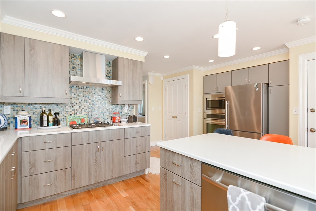 269 Webster Street, Unit 4 Boston, MA 02128 - Photo 12 of 36 a kitchen that has a lot of cabinets and wooden floor