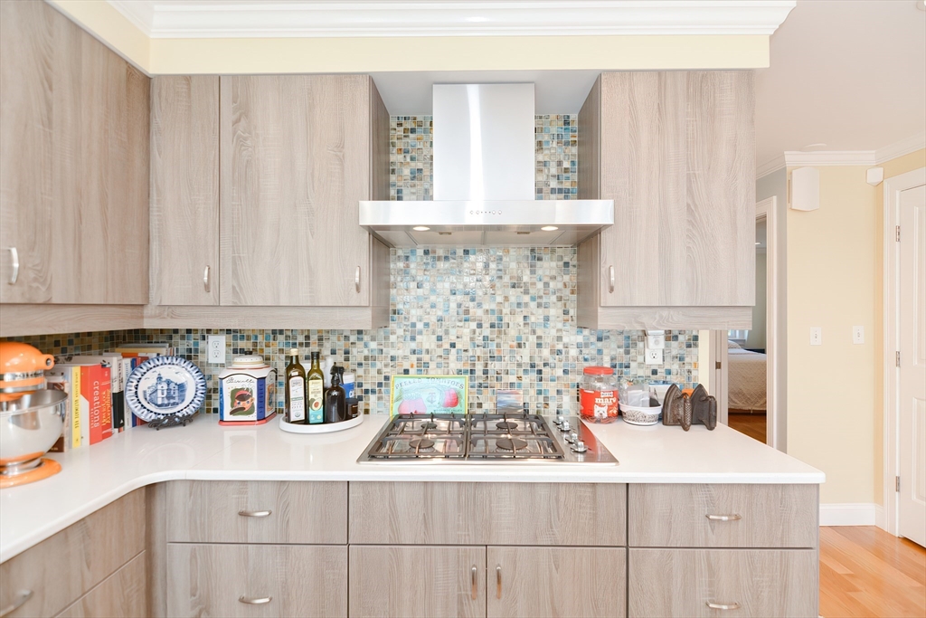 269 Webster Street, Unit 4 Boston, MA 02128 - Photo 13 of 36 a kitchen with a stove and cabinets