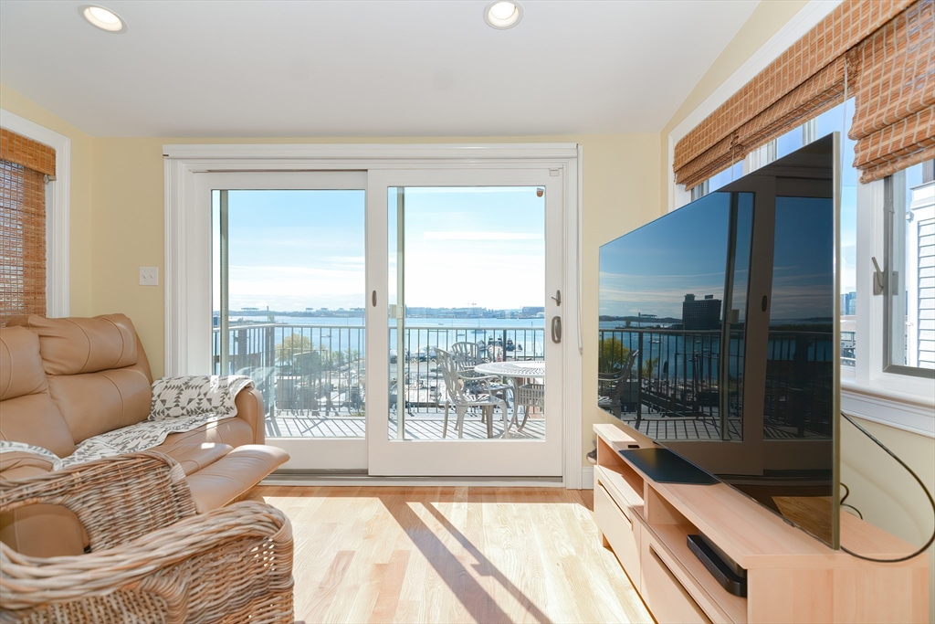 269 Webster Street, Unit 4 Boston, MA 02128 - Photo 14 of 36 a living room with furniture and a floor to ceiling window