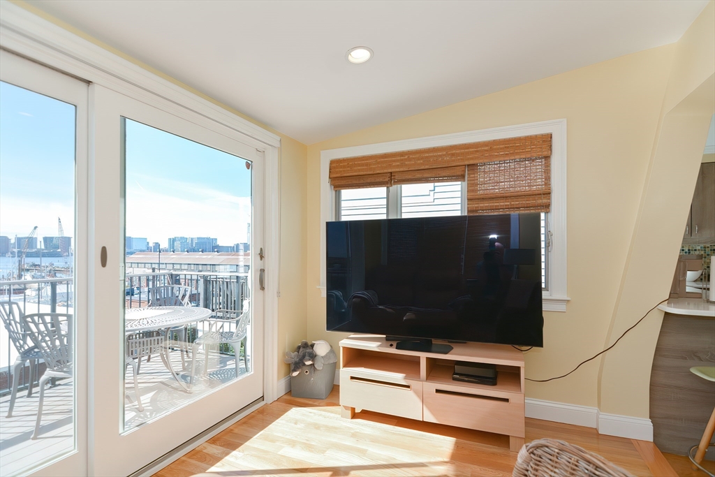 269 Webster Street, Unit 4 Boston, MA 02128 - Photo 17 of 36 a living room with furniture and a flat screen tv