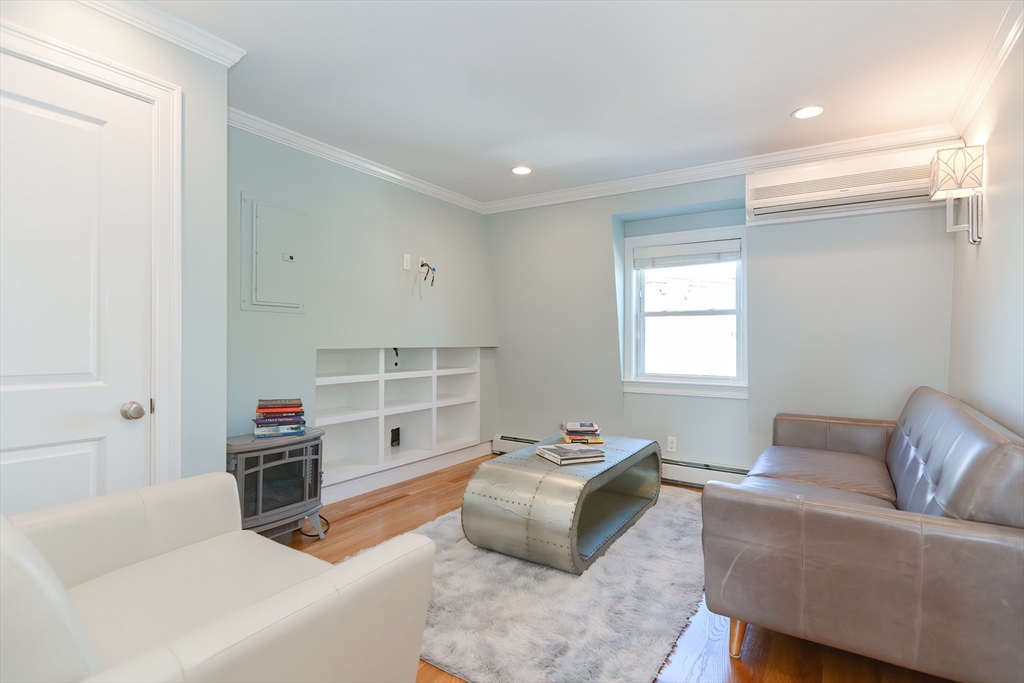 269 Webster Street, Unit 4 Boston, MA 02128 - Photo 18 of 36 a living room with furniture and a window
