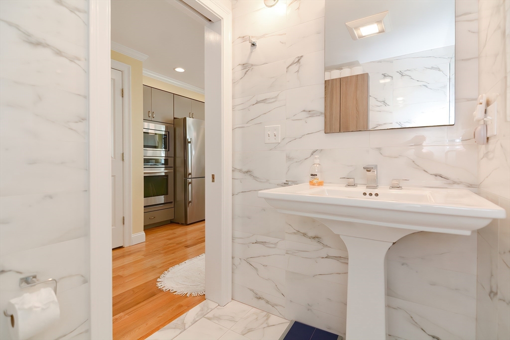 269 Webster Street, Unit 4 Boston, MA 02128 - Photo 21 of 36 a bathroom with a sink a mirror and a shower