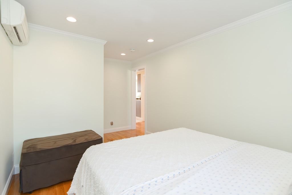 269 Webster Street, Unit 4 Boston, MA 02128 - Photo 24 of 36 a bedroom with a bed and a couch