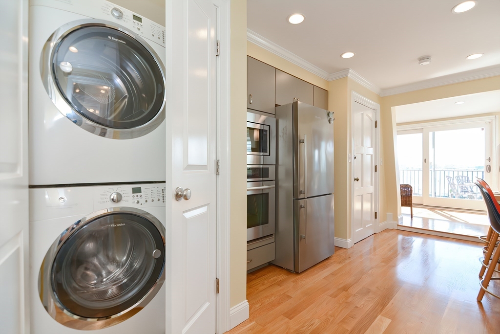 269 Webster Street, Unit 4 Boston, MA 02128 - Photo 25 of 36 a view of a hallway with washer and dryer