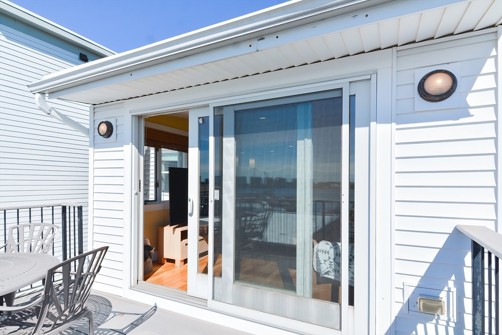 269 Webster Street, Unit 4 Boston, MA 02128 - Photo 26 of 36 a view of a door and chair in a balcony