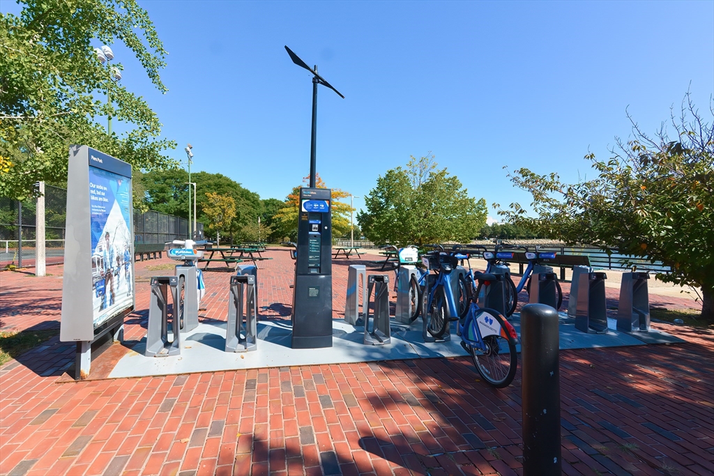 269 Webster Street, Unit 4 Boston, MA 02128 - Photo 30 of 36 a view of a balcony with chairs and wooden floor