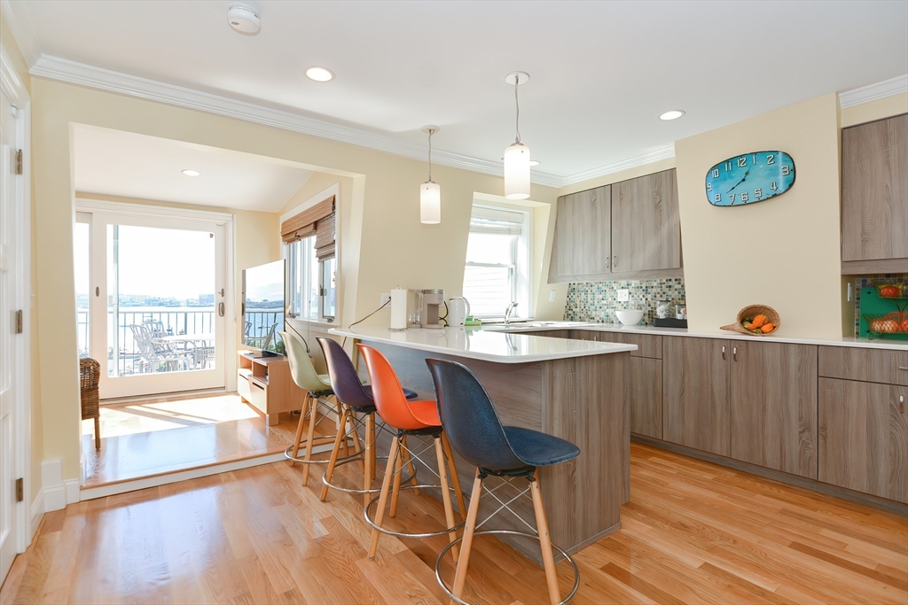 269 Webster Street, Unit 4 Boston, MA 02128 - Photo 7 of 36 a dining room with wooden floor and large window