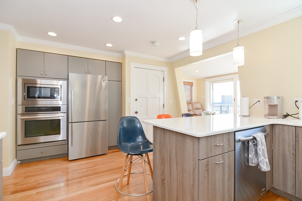 269 Webster Street, Unit 4 Boston, MA 02128 - Photo 9 of 36 a kitchen with a sink stainless steel appliances and cabinets