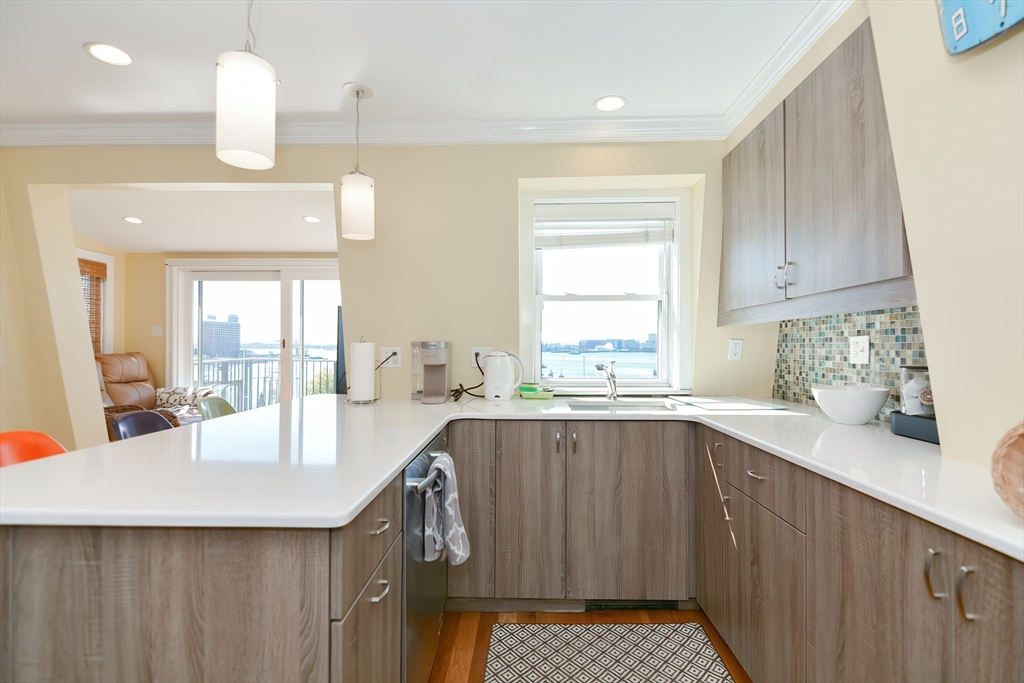 269 Webster Street, Unit 4 Boston, MA 02128 - Photo 10 of 36 a kitchen with a sink cabinets and window