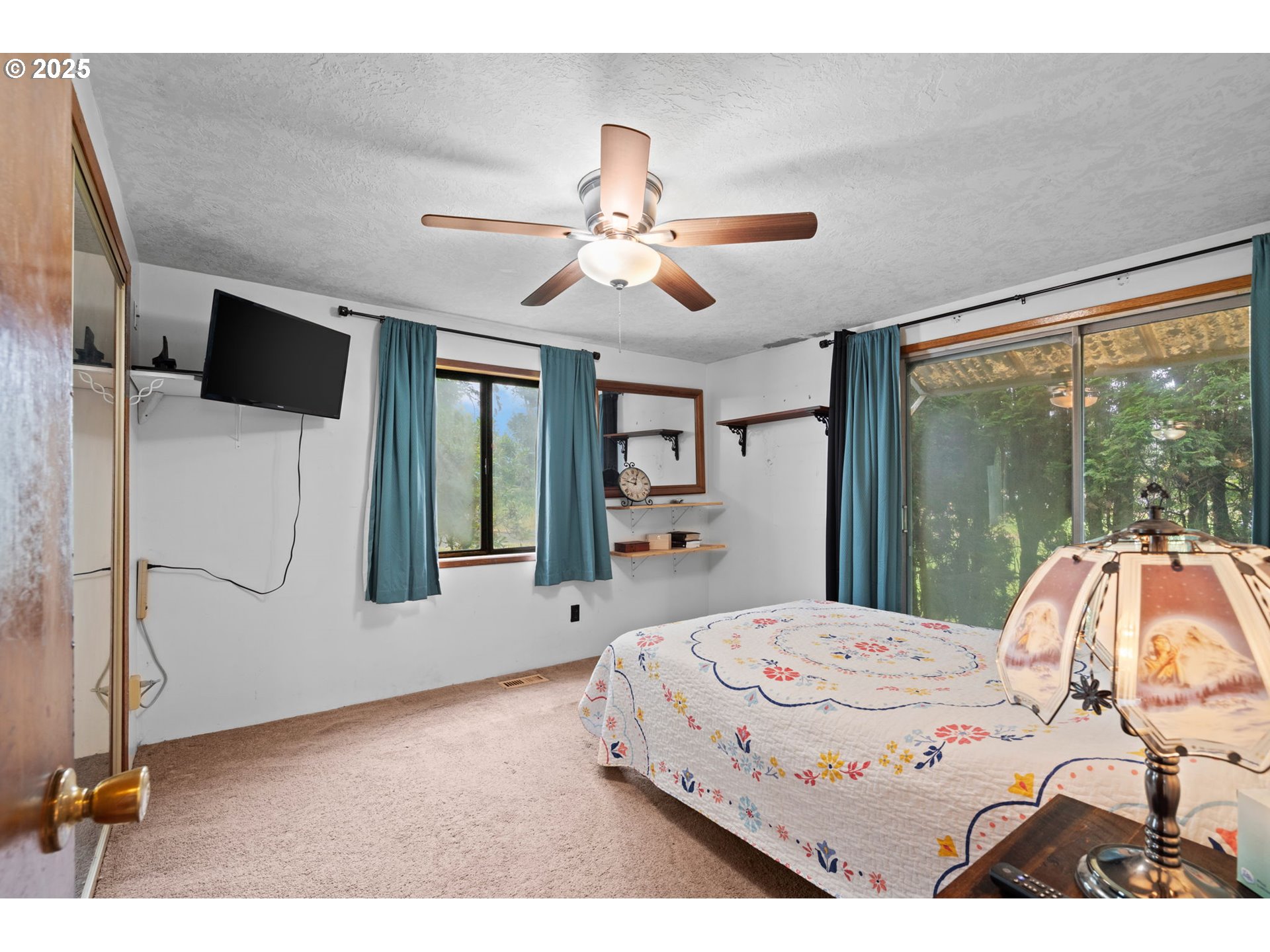 472 7th Avenue Hammond, OR 97121 - Photo 12 of 32 a bedroom with a large bed and a chandelier