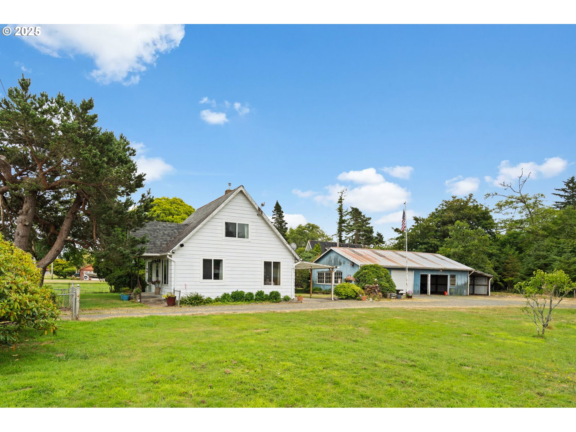 472 7th Avenue Hammond, OR 97121 - Photo 19 of 32 a front view of a house with a garden