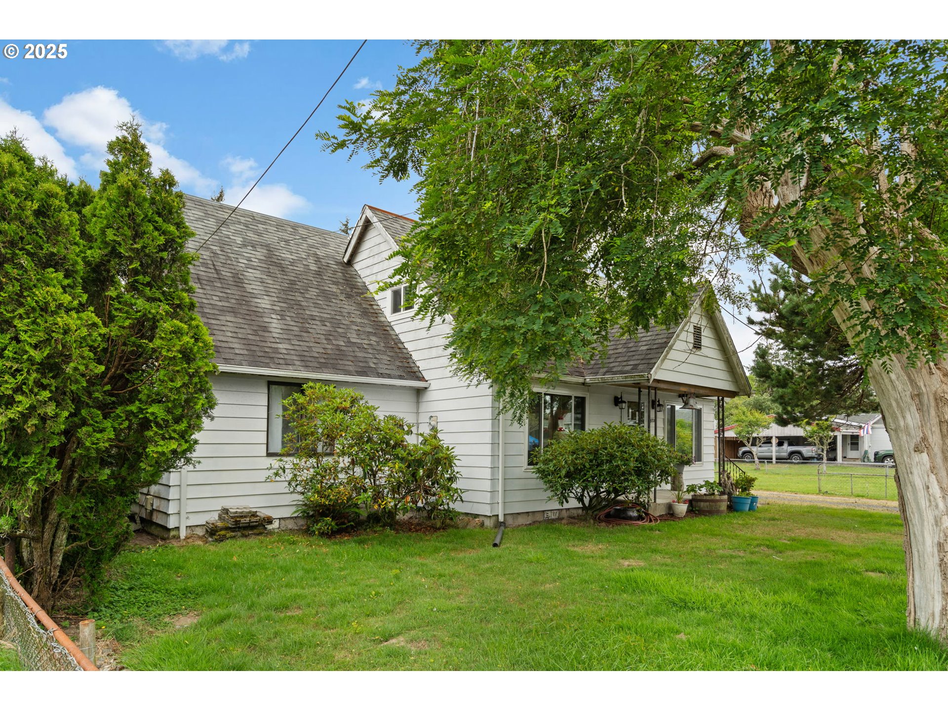 472 7th Avenue Hammond, OR 97121 - Photo 2 of 32 a front view of a house with a garden