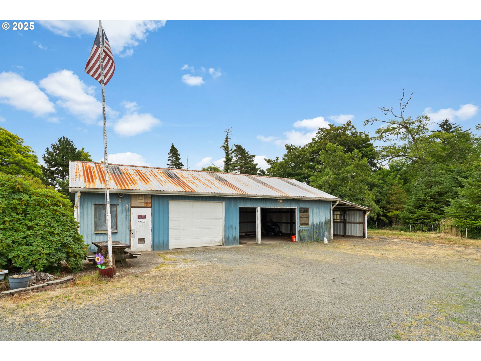 472 7th Avenue Hammond, OR 97121 - Photo 23 of 32 a front view of a house with a garden