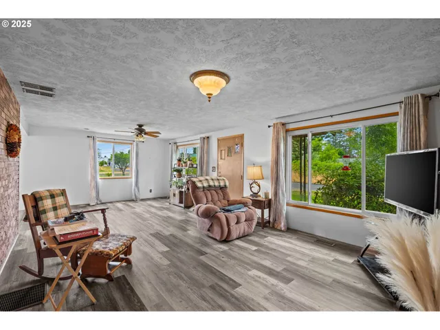 a view of a livingroom with furniture and a window