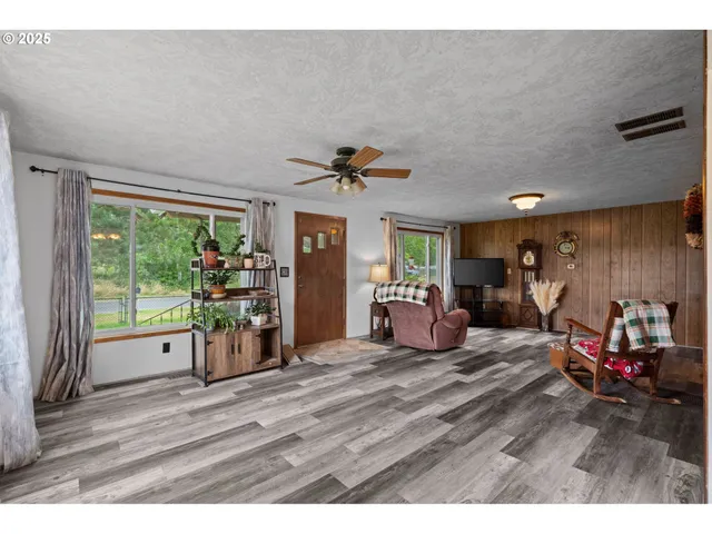 a bedroom with furniture and a large window