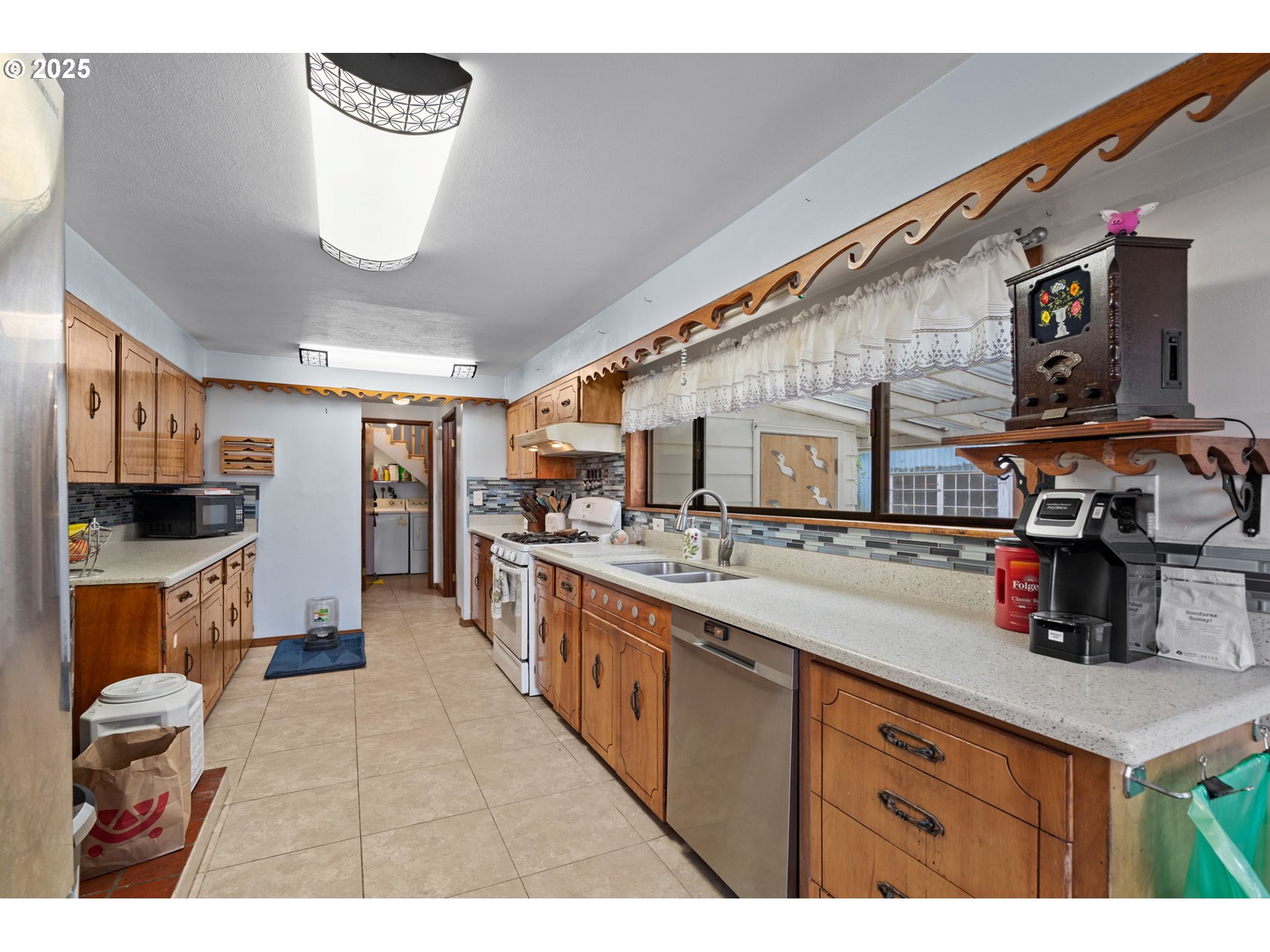 472 7th Avenue Hammond, OR 97121 - Photo 9 of 32 a kitchen with a sink and a stove top oven