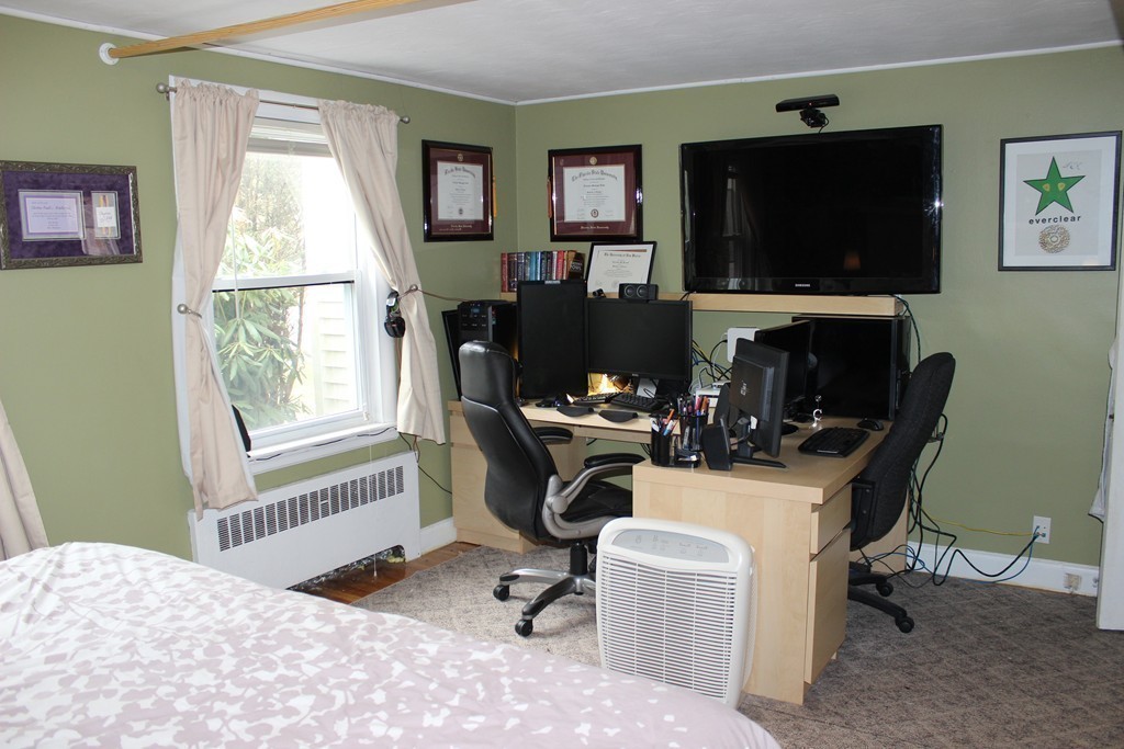 165-167 Langley Road Newton, MA 02459 - Photo 14 of 37 a view of a workspace with a window and a flat screen tv
