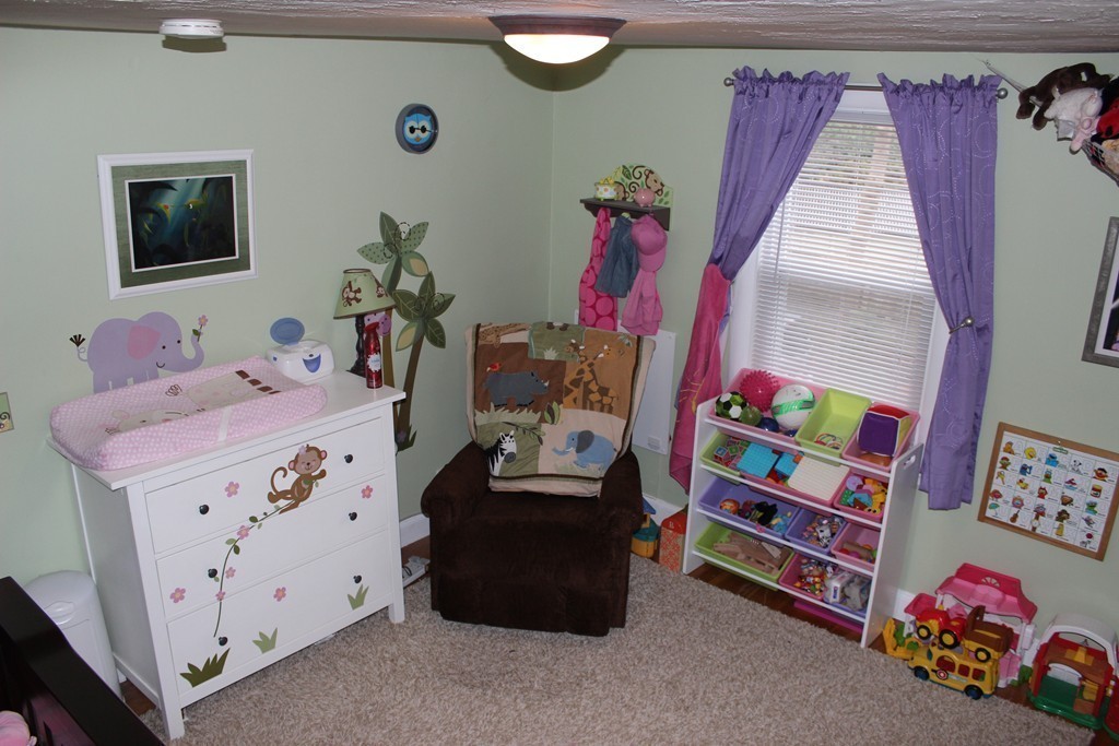 165-167 Langley Road Newton, MA 02459 - Photo 15 of 37 a bedroom with a bed and a dresser