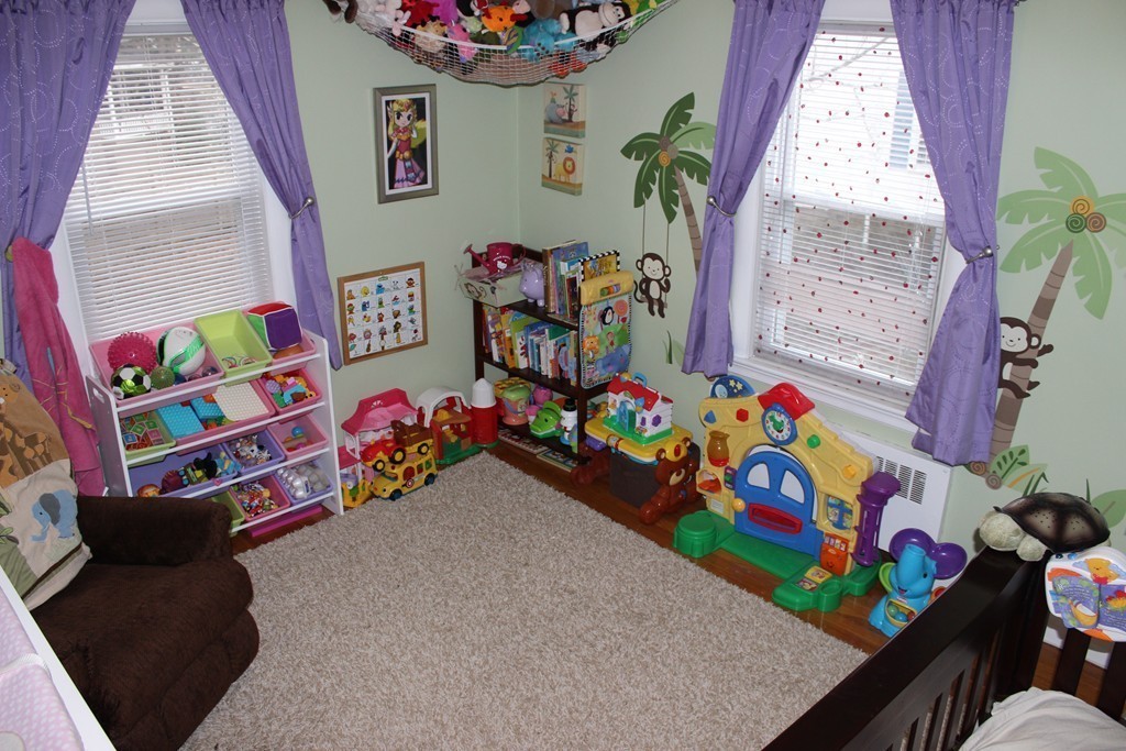 165-167 Langley Road Newton, MA 02459 - Photo 16 of 37 a kids room with toys and a couch