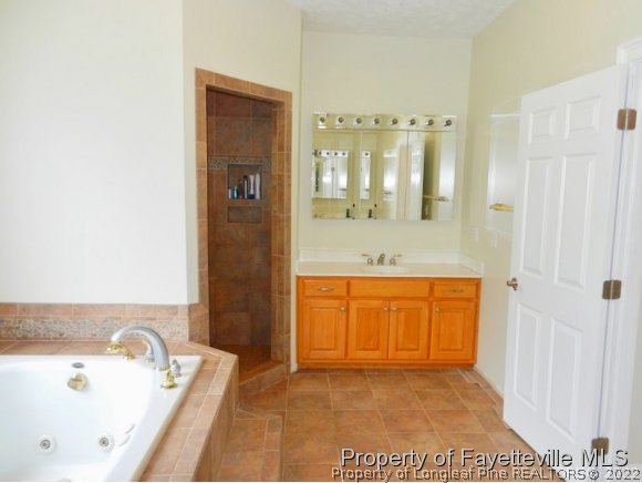 1059 McGougan Road Lumber Bridge, NC 28357 - Photo 16 of 25 a bathroom with a tub sink and mirror
