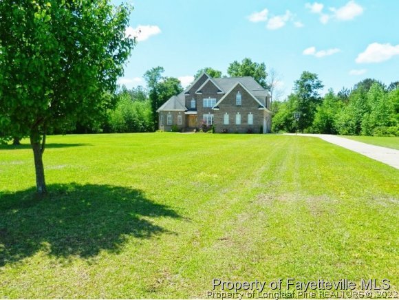 1059 McGougan Road Lumber Bridge, NC 28357 - Photo 2 of 25 a house view with a garden space