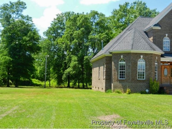 1059 McGougan Road Lumber Bridge, NC 28357 - Photo 5 of 25 a view of a house with a yard