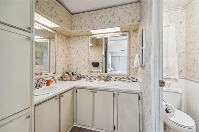 a white toilet sitting next to a bathroom sink