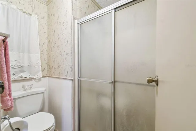 a view of a livingroom with a ceiling fan and window