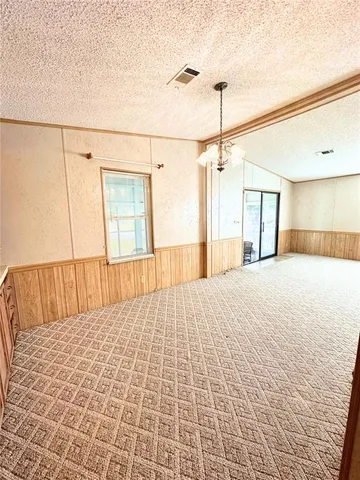 a dining room with furniture and a floor to ceiling window