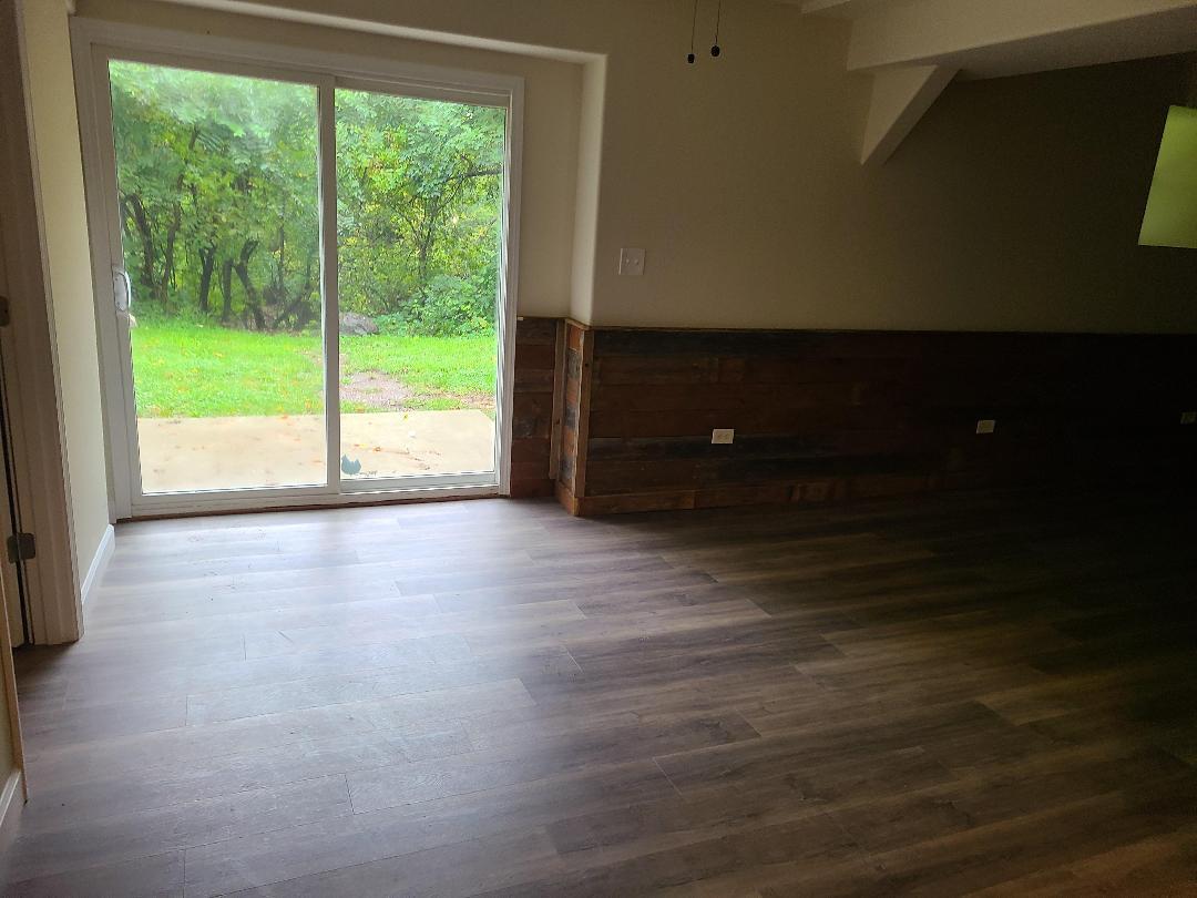 2103 Main Street, Unit L Spring Grove, IL 60081 - Photo 2 of 9 a view of room with hardwood floor and window